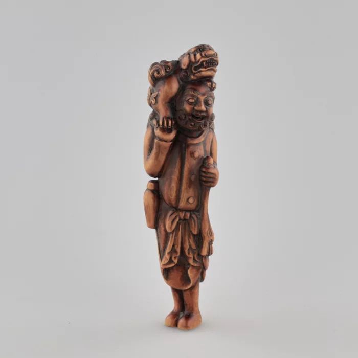 Wooden netsuke Traveler with a dog on his head Tadakazu style 1819 century.