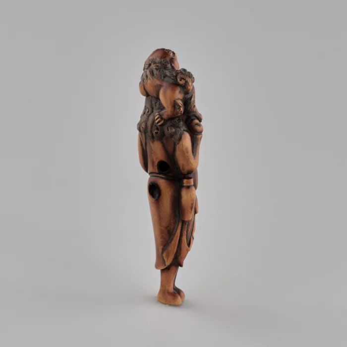 Wooden netsuke Traveler with a dog on his head Tadakazu style 1819 century.