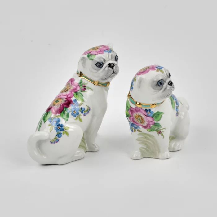 A pair of Pugs figures.