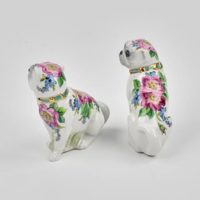 A pair of Pugs figures.