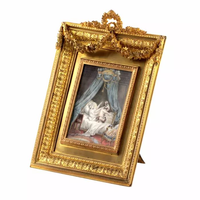 Playful miniature  in a gold frame. 