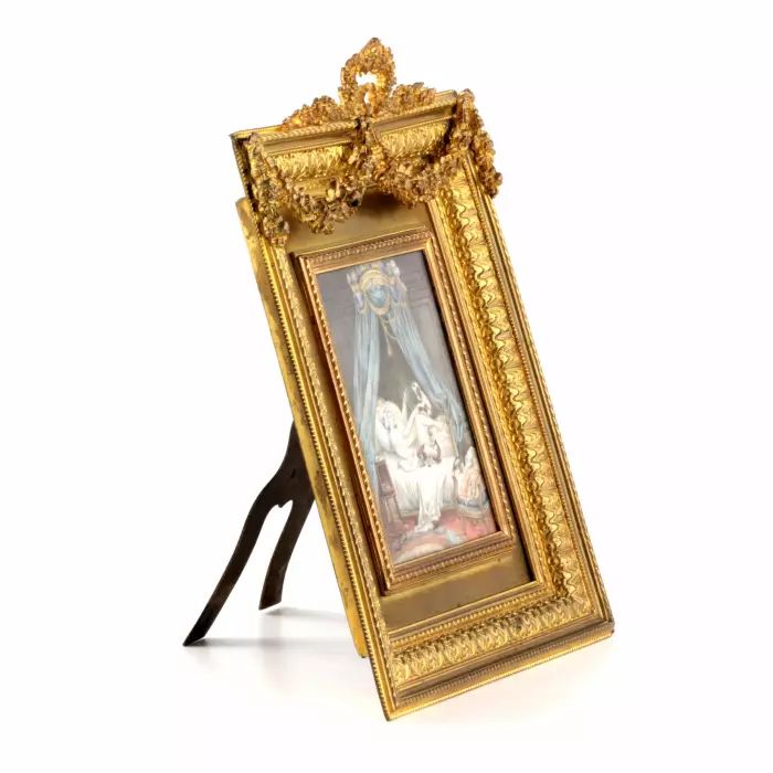 Playful miniature  in a gold frame. 