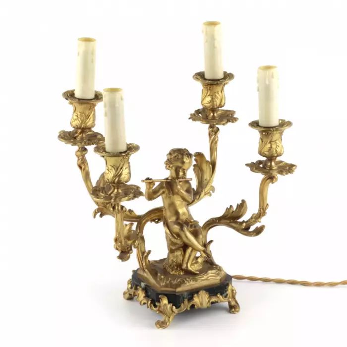 Paired lamps of gilded bronze with cupids playing music. 