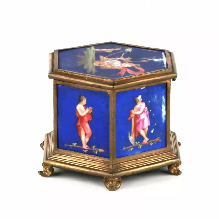 Brass box with muses, on porcelain panels. 