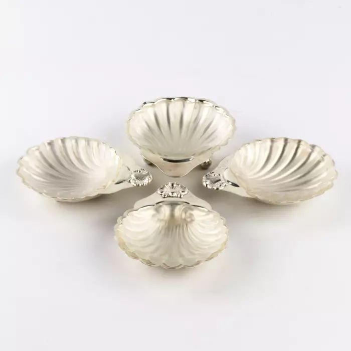 Four silver caviar saucers. 