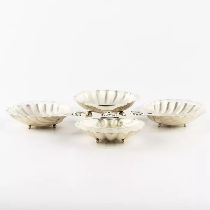 Four silver caviar saucers. 