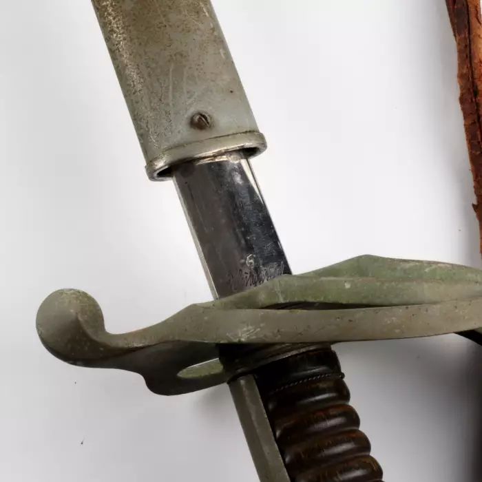 Shaped sword with a steel hilt and scabbard. 