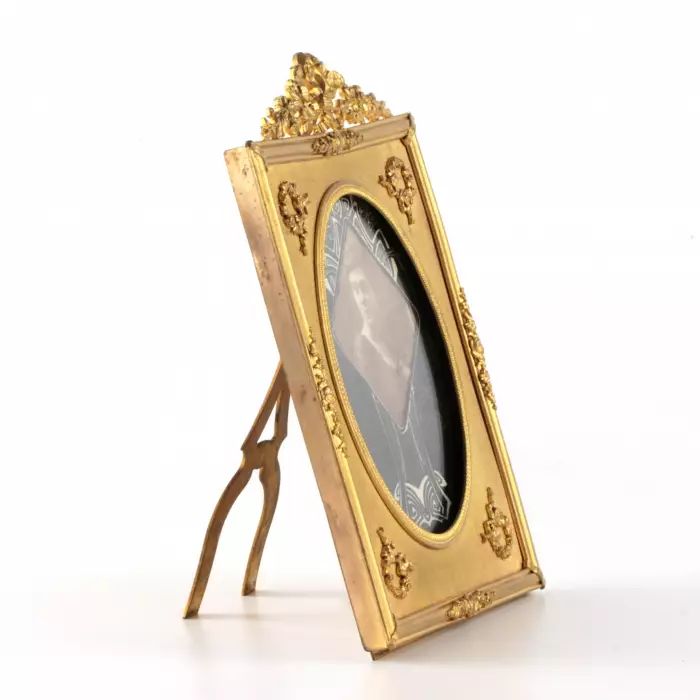 Photo frame of gilded bronze in the style of neoclassicism. 