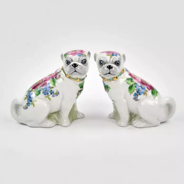 A pair of Pugs figures.