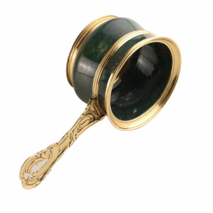 Magnifier in gold frame.