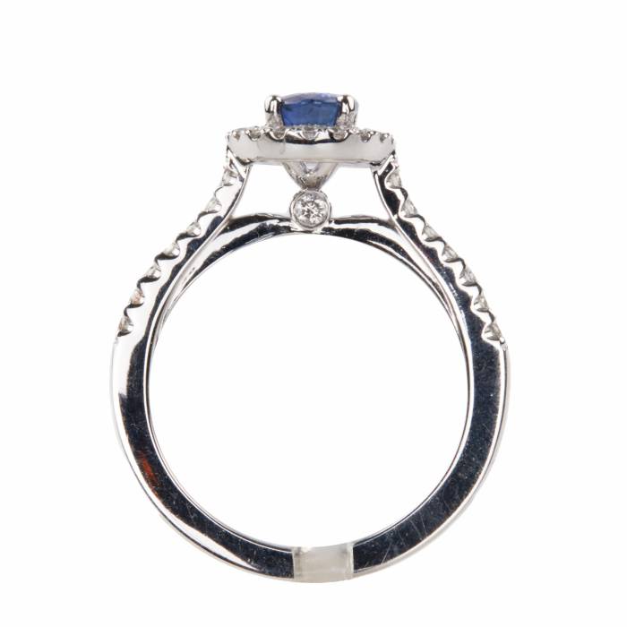 White gold ring with blue sapphire and diamonds. 