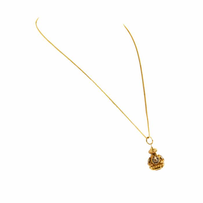 Pendant on a chain with stones. 