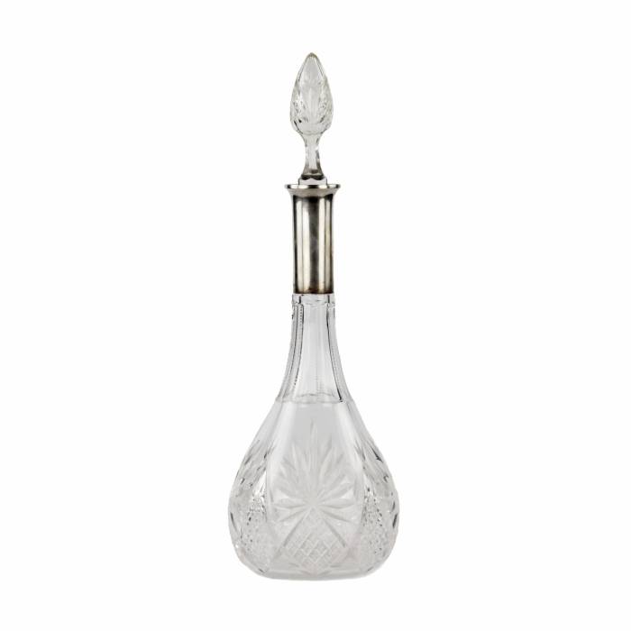 Crystal decanter with a silver neck. 