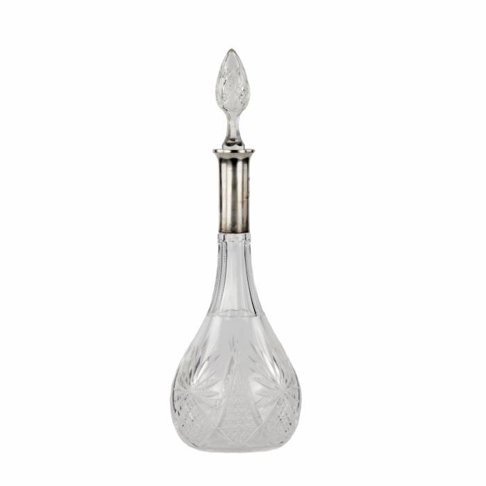 Crystal decanter with a silver neck. 