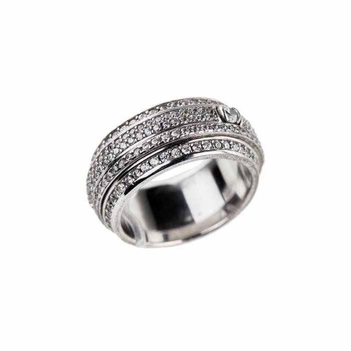 Ring with Swarovski crystals. ----White metal ring with Swarovski rhinestones. Ring with two freely rotating parts in the center of the ring. Rhinestones are located around the rim of the ring. Product size: 15