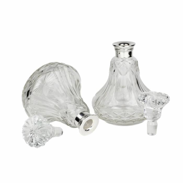 Pair of crystal, pear-shaped decanters with silver necks. 20th century. 