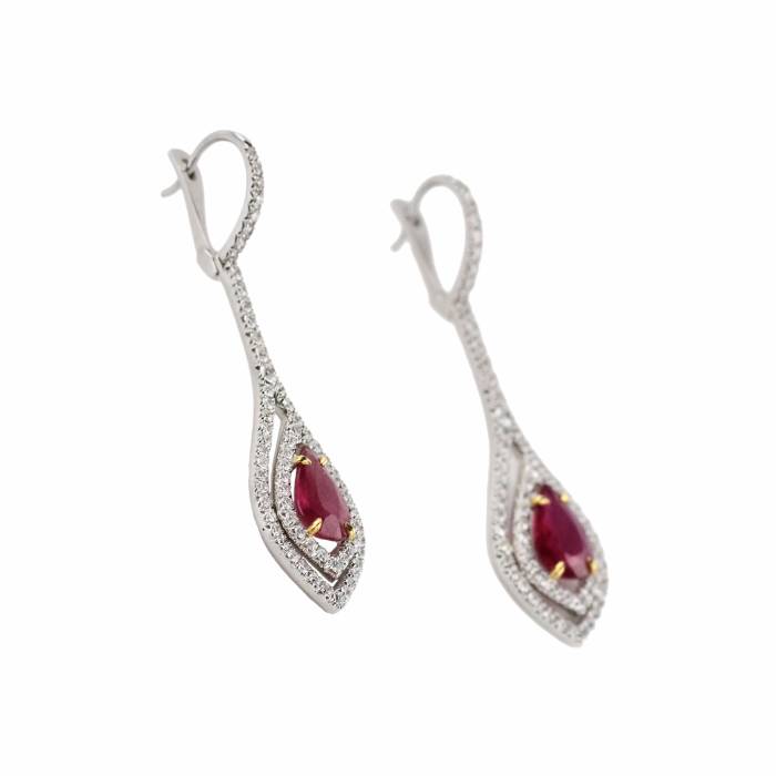 Long, 18K gold earrings with rubies and diamonds. 