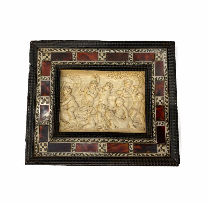 A carved bone panel depicting Putti playing. Germany 18th century