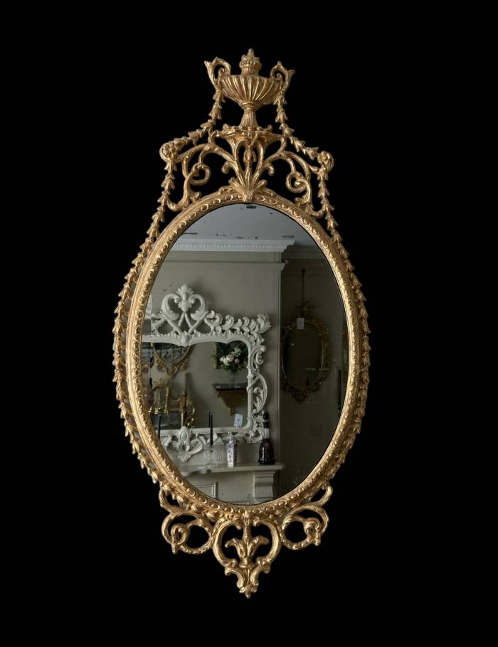 An elegant George III giltwood and carton-pierre oval pier glass, late 18th Century