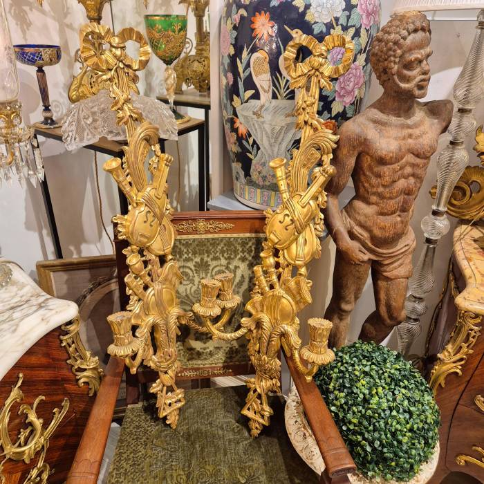 Pair of two-light gilded wood wall sconces in the Louis XVI style, 19th century