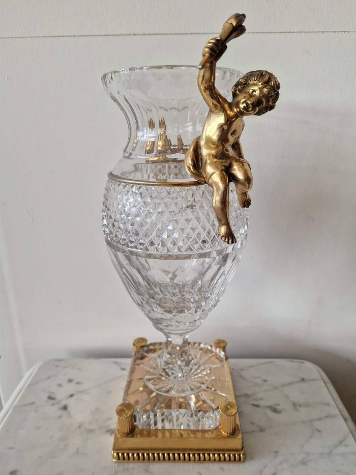 Bohemian crystal vase with bronze puti.