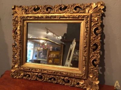 The mirror in a carved frame