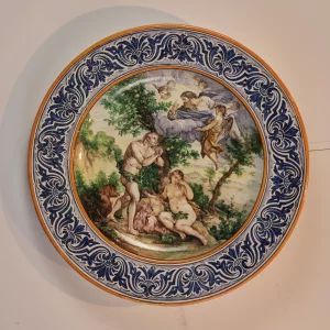 A dish of Italian majolica "Expulsion from Paradise".