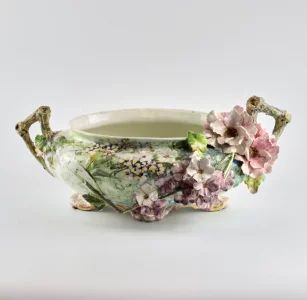 Liberty style faience pot with sprouting flowers.