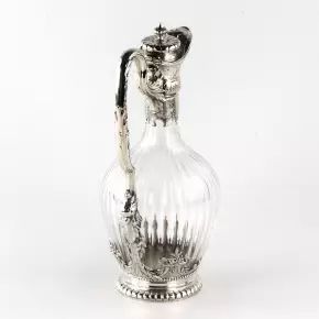 Silver wine jug in "16th century austere male dress." 