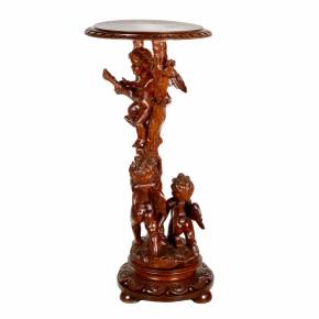 Wooden console with carved cupids. 